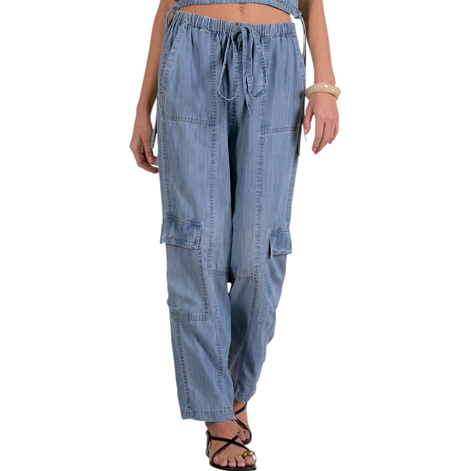 Light blue denim cargo pants worn by a person on a white background