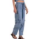 Blue denim cargo pants worn by a person on a white background