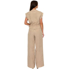 Woman wearing a beige set on a white background