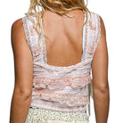 Back view of a woman wearing a lace-trimmed sleeveless top on a white background