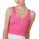 Person wearing a pink tank top on a white background
