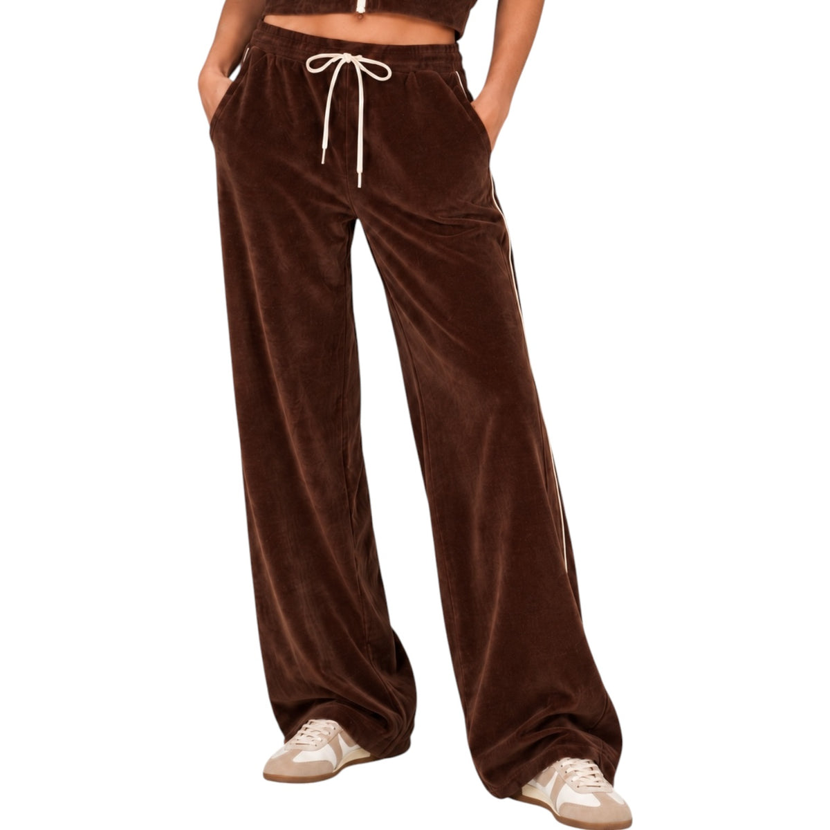 A person wearing wide-leg brown velvet pants with a white drawstring waist, shown from the torso down against a plain white background.