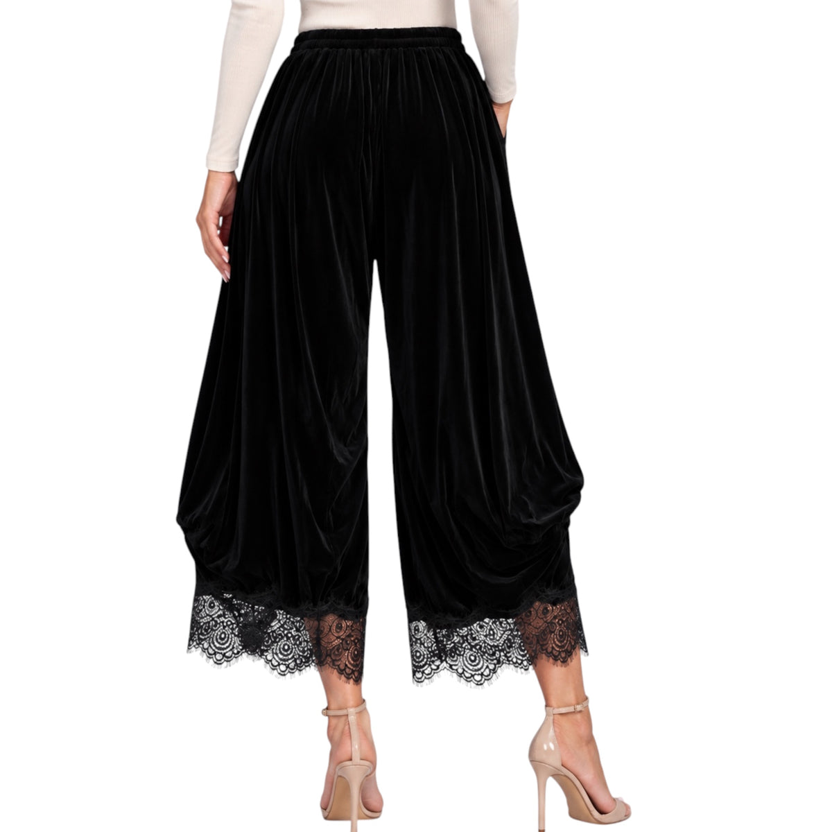 Black velvet wide-leg cropped pants with a lace hem, shown on a model from the waist down wearing beige high heels against a white background.