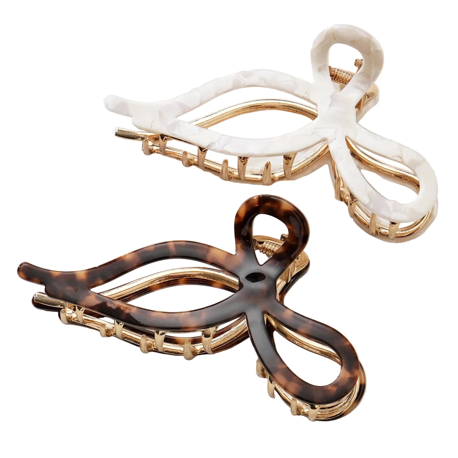 Two hair clips, one white and one tortoiseshell, on a light background