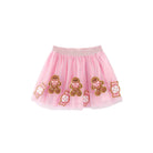 A pink tulle tutu skirt for toddlers, decorated with embroidered gingerbread men and candy motifs on a solid white background.