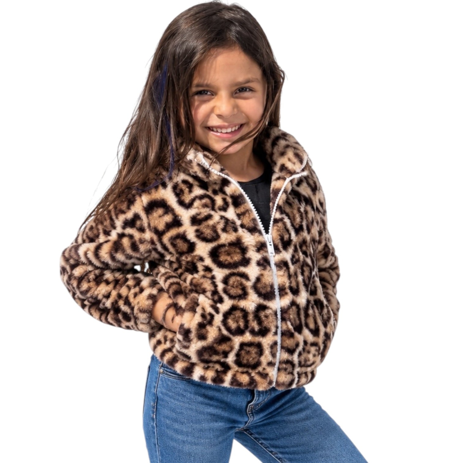 A young girl smiling while wearing a fuzzy leopard-print fleece jacket with a white zipper, paired with blue jeans, against a solid white background.