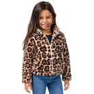 A young girl smiling while wearing a leopard print fleece zip-up jacket with white trim, paired with blue jeans, against a plain white background.