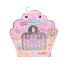 A package of Pop Nail Oils press-on nails and matching rings in a cute pink cupcake-shaped box. The nails feature various pastel colors and whimsical cartoon designs, including a bunny and a unicorn, and are displayed in a clear window on the front of the packaging.