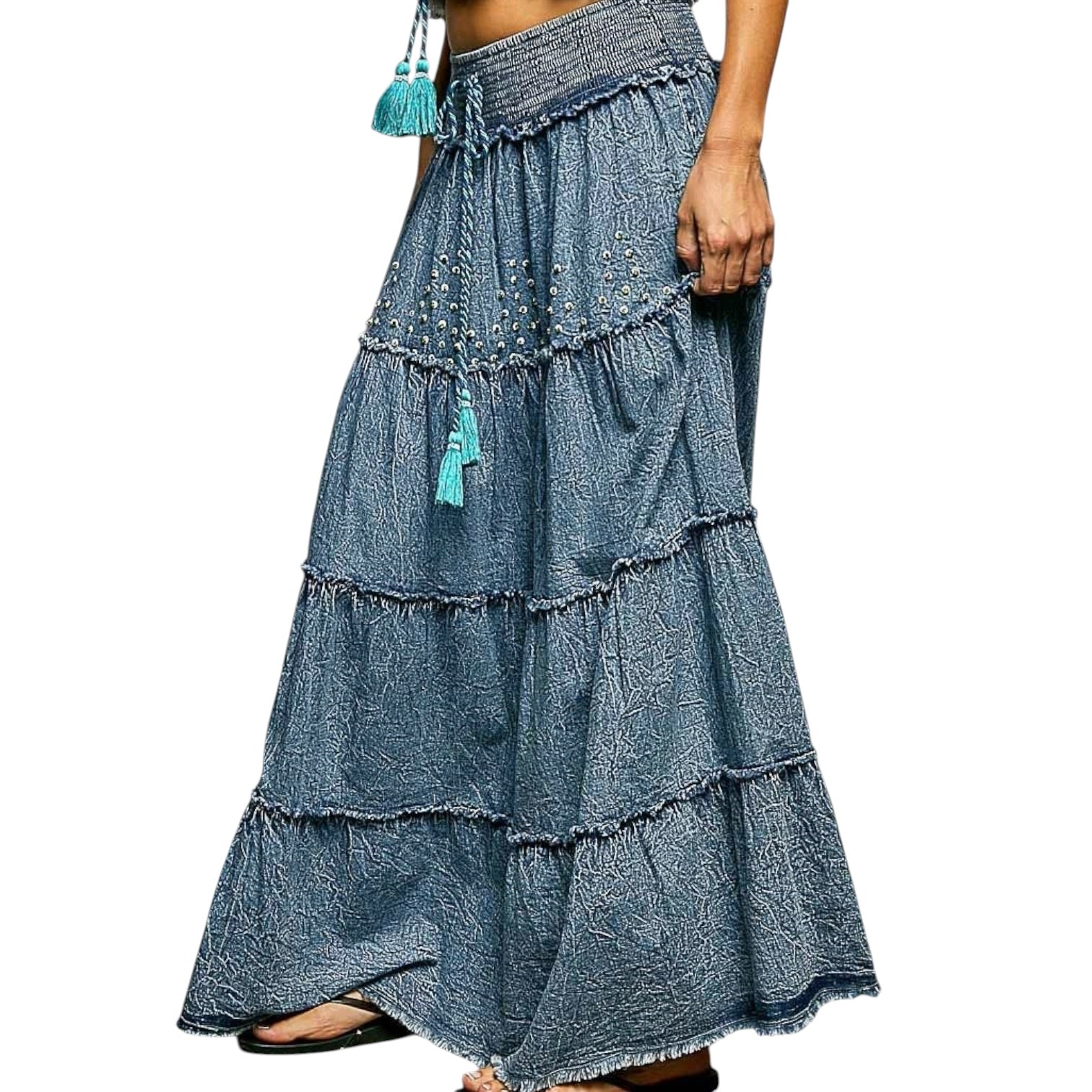 Denim tiered skirt with tassels on a white background