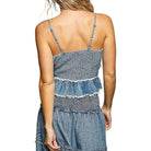 Denim dress with ruffled layers on a white background
