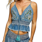 Denim top with paisley patterns and tassels on a white background