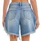 Blue denim shorts with frayed edges on a white background