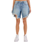 Denim shorts with frayed edges worn by a person on a white background