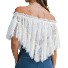White lace off-shoulder top worn by a person on a white background