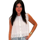 a woman wearing a white eyelet button down tank top on white background