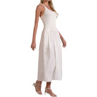 Woman wearing a white sleeveless dress on a white background