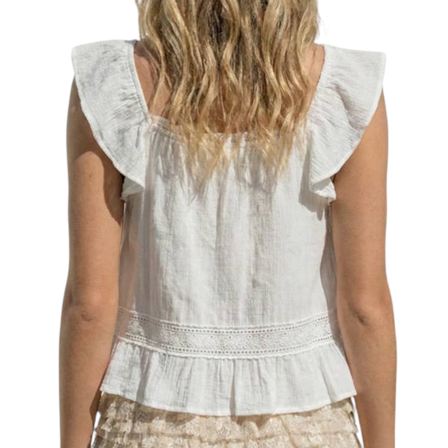 White sleeveless top with ruffled shoulders worn by a person on a white background