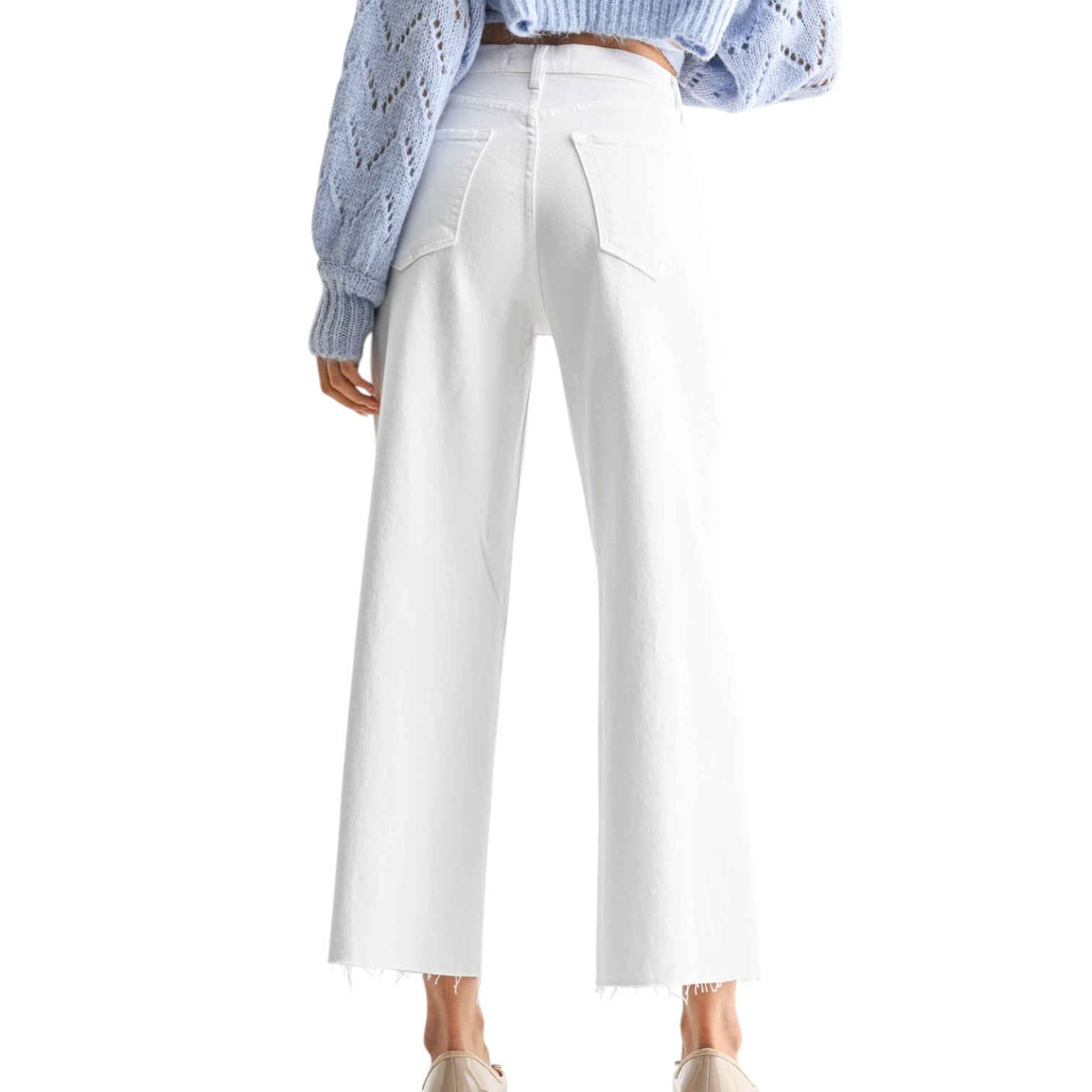 White pants worn by a person on a white background