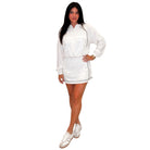 Woman wearing a white set with long sleeves on a white background