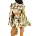 a woman wearing a printed pleated romper on white background