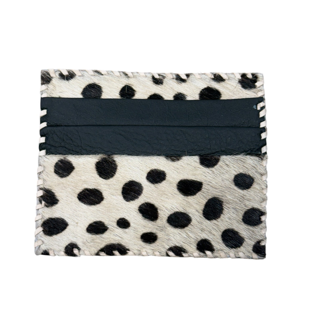 A square card holder or wallet featuring a black and white cowhide dalmatian spot pattern with a wide black leather band across the center, shown on a plain white background.