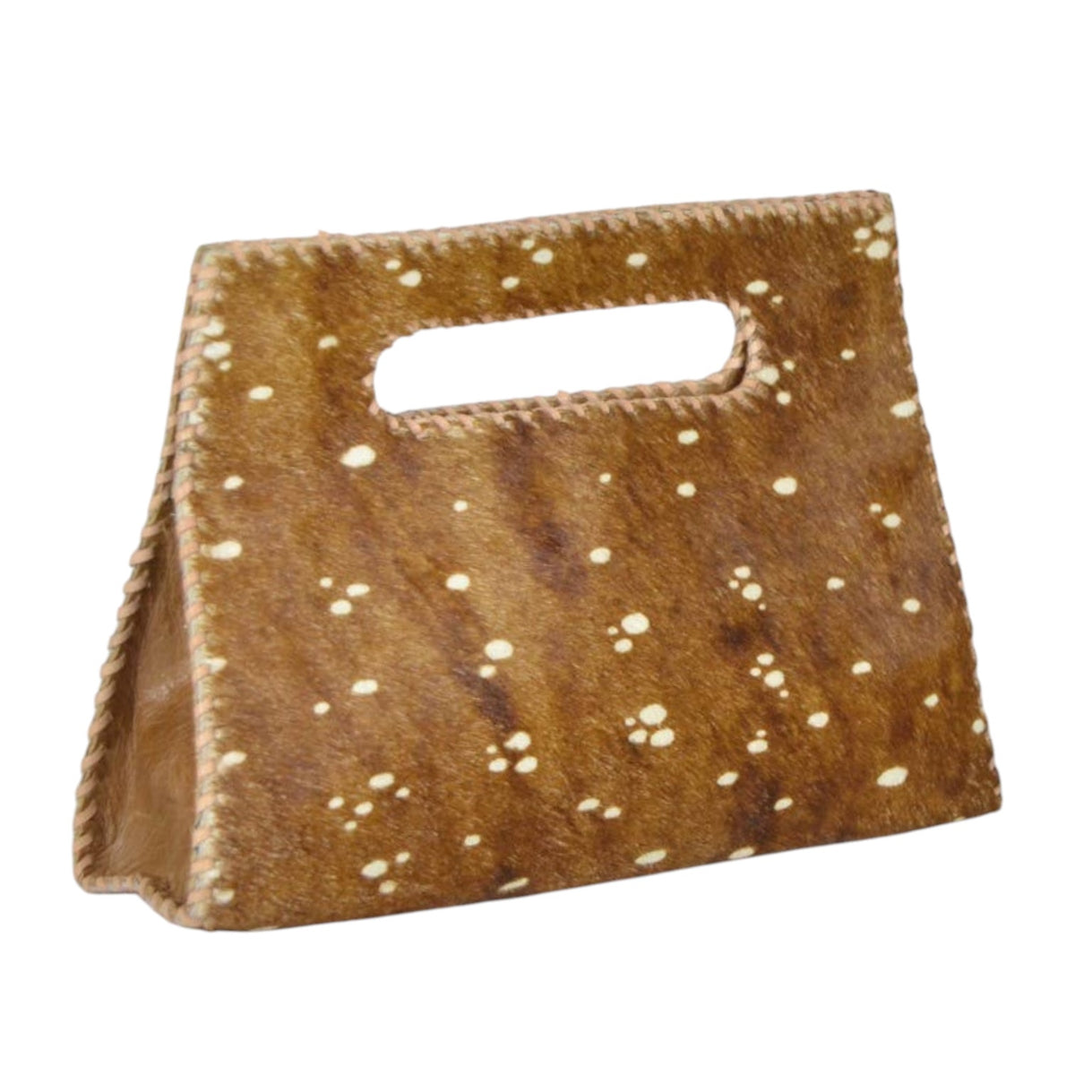 A small structured handbag made from brown cowhide with white speckled spots and a cutout handle, shown on a plain white background.