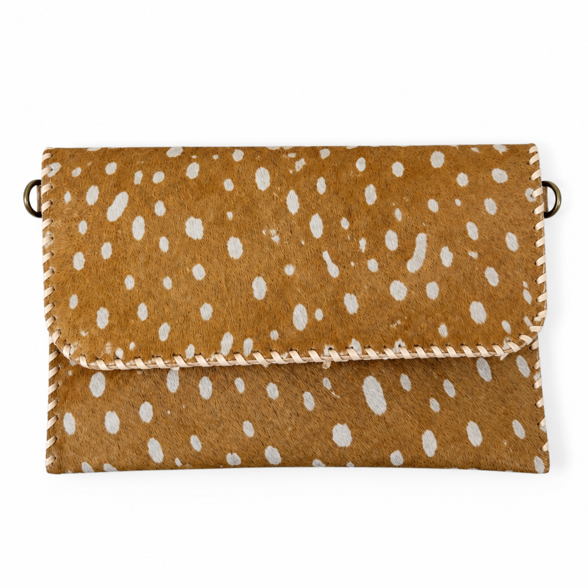 A brown faux-hair clutch bag with a white spotted pattern, featuring whipstitched edges and a small metal ring on each side.