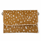 A brown faux-hair clutch bag with a white spotted pattern, featuring whipstitched edges and a small metal ring on each side.