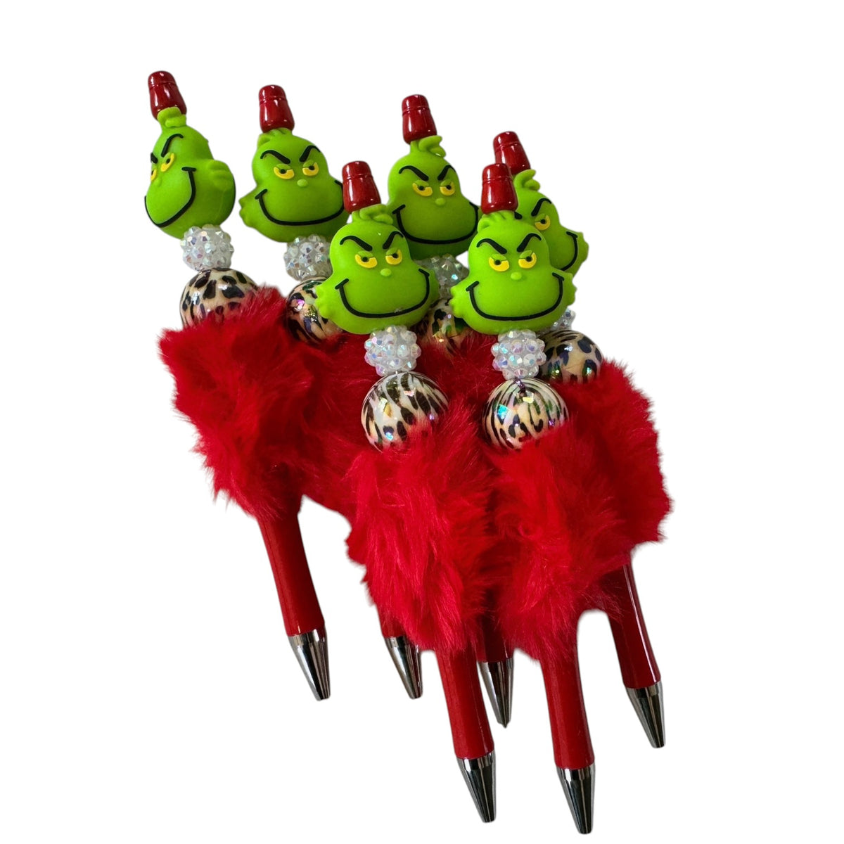 Set of pens with Grinch faces on red handles with feathers