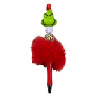 Decorative pen with Grinch face, red fluffy top, and gold and silver accents on a white background