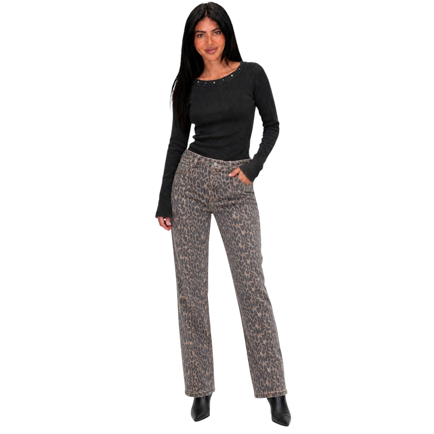 A woman modeling a black long-sleeve top and high-waisted, straight-leg trousers with a brown and beige leopard print, set against a plain white background.