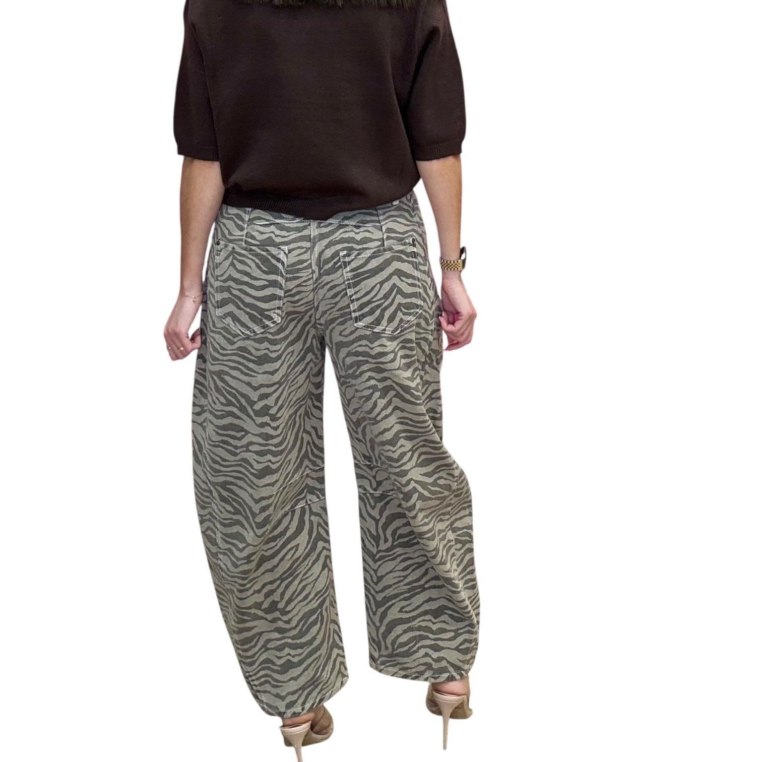 Person wearing zebra print pants on a white background