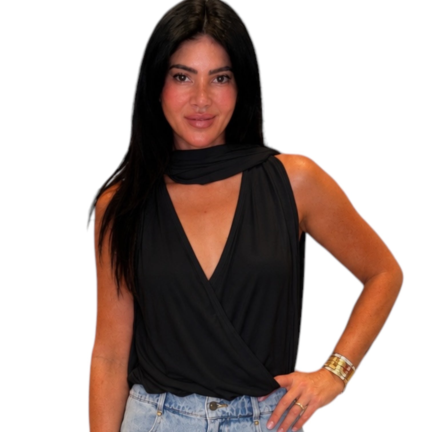 Woman wearing a black sleeveless top and blue jeans on a white background