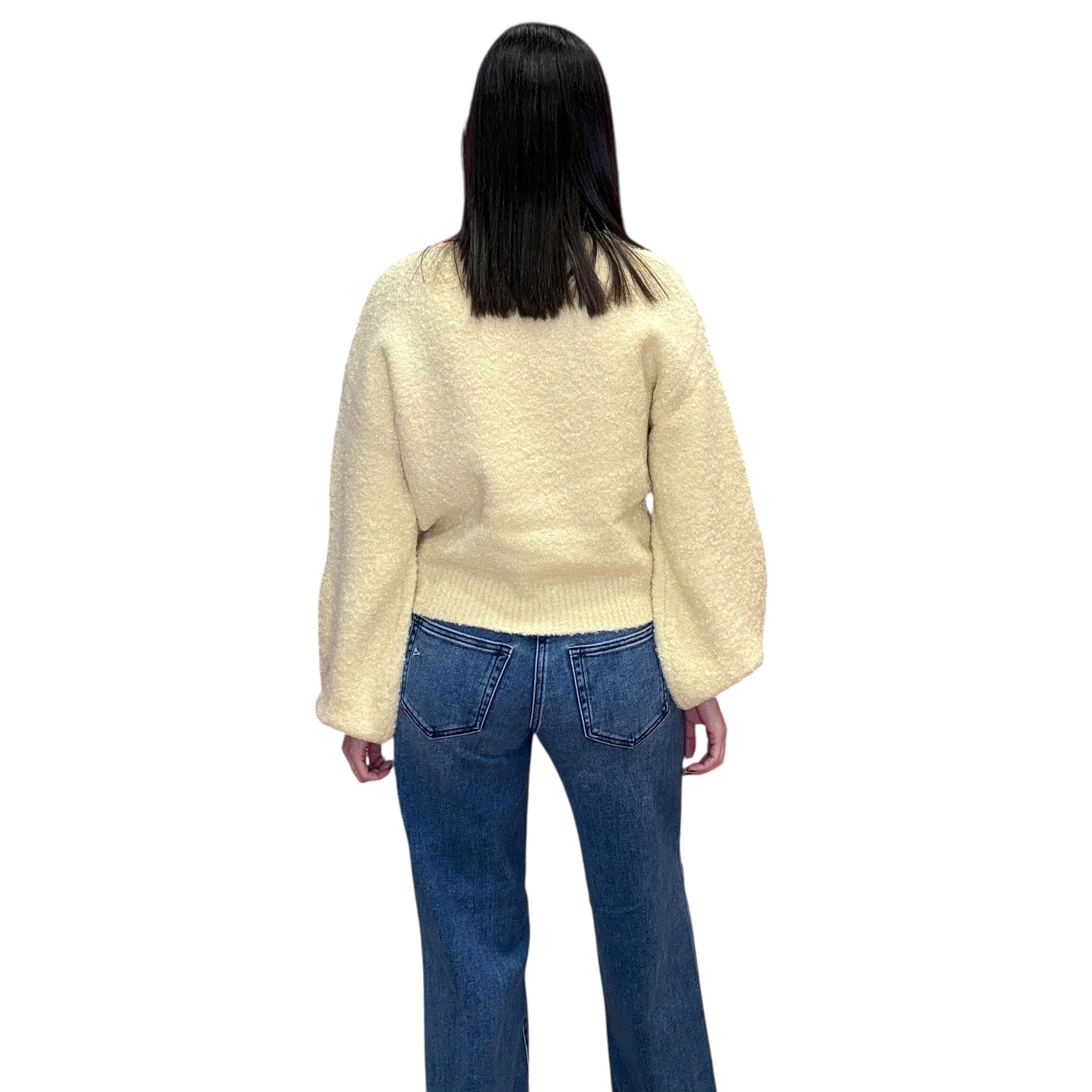 Person wearing a yellow sweater and blue jeans on a white background