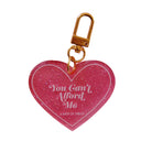 Pink glitter heart keychain with gold clasp on a white background
