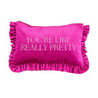 A bright pink velvet cosmetic pouch with ruffled trim on all sides and the text 'YOU'RE LIKE REALLY PRETTY' embroidered in white across the front.