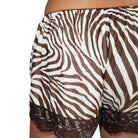 Brown and white zebra print sheer shorts with a dark brown lace hem, shown on a model against a white background.