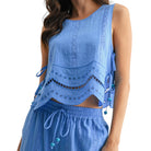 Blue sleeveless top with lace details on a white background