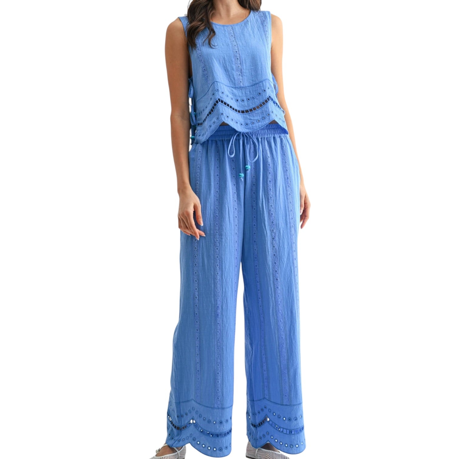 Woman wearing a blue set with lace details on a white background