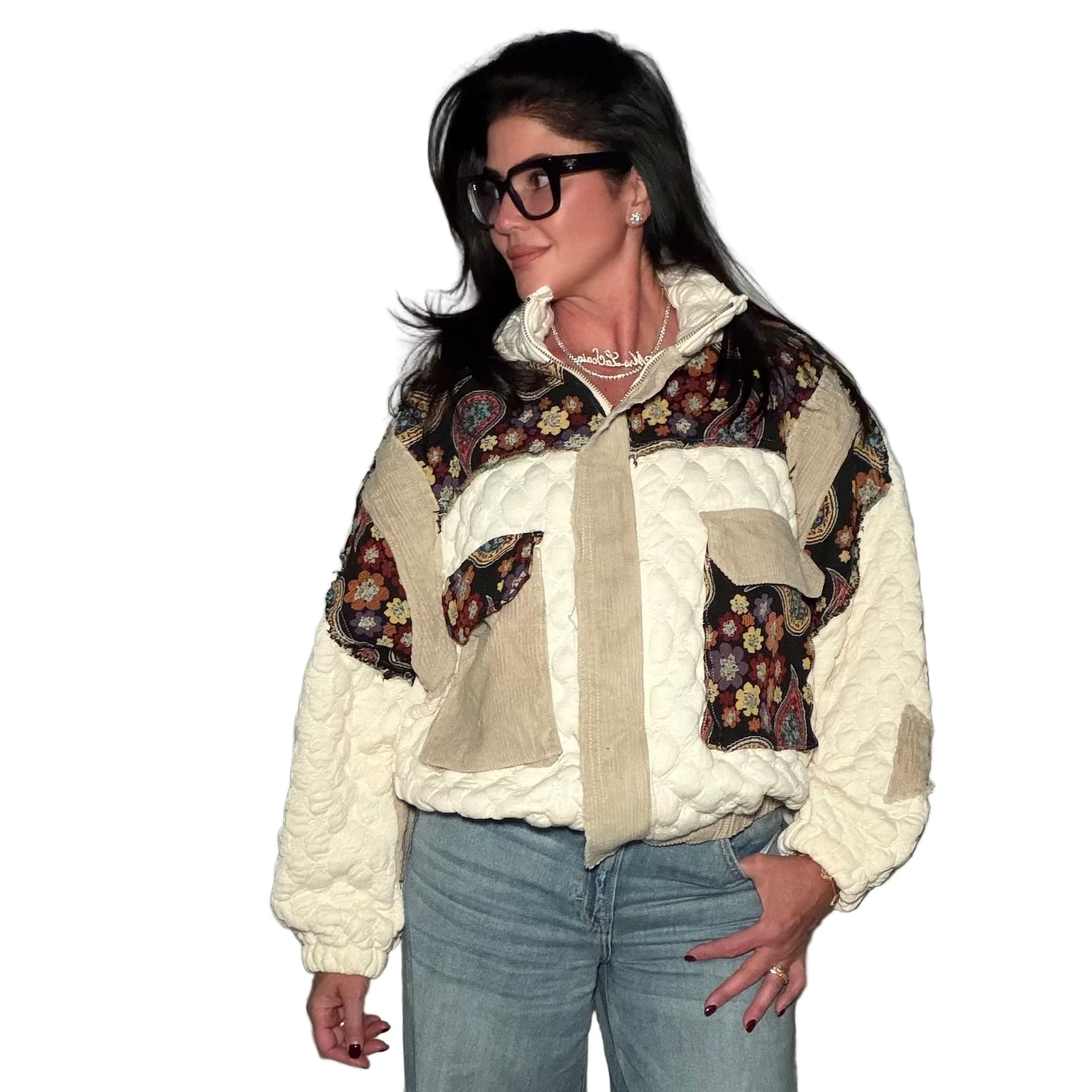 Person wearing a patterned jacket with a neutral background