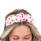 Woman wearing a heart-patterned headband.
