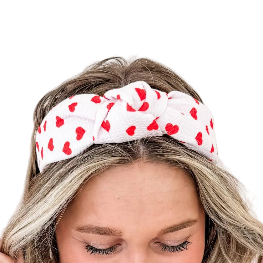 Woman wearing a heart-patterned headband.