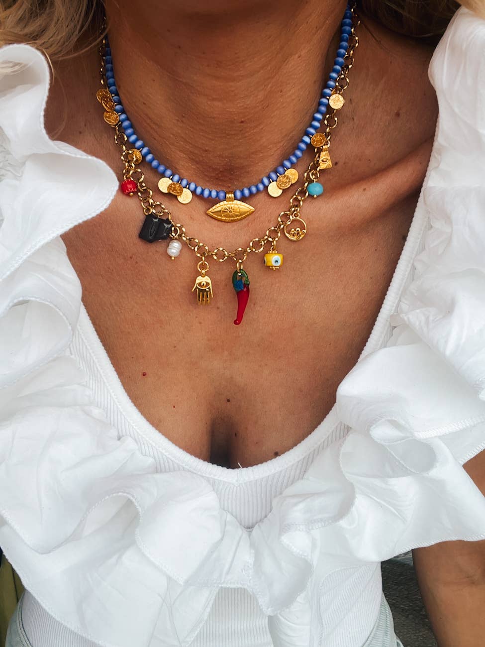 Multi charm gold necklace with blue beads, Freshwater pearl, and colorful charms, perfect for summer styling.