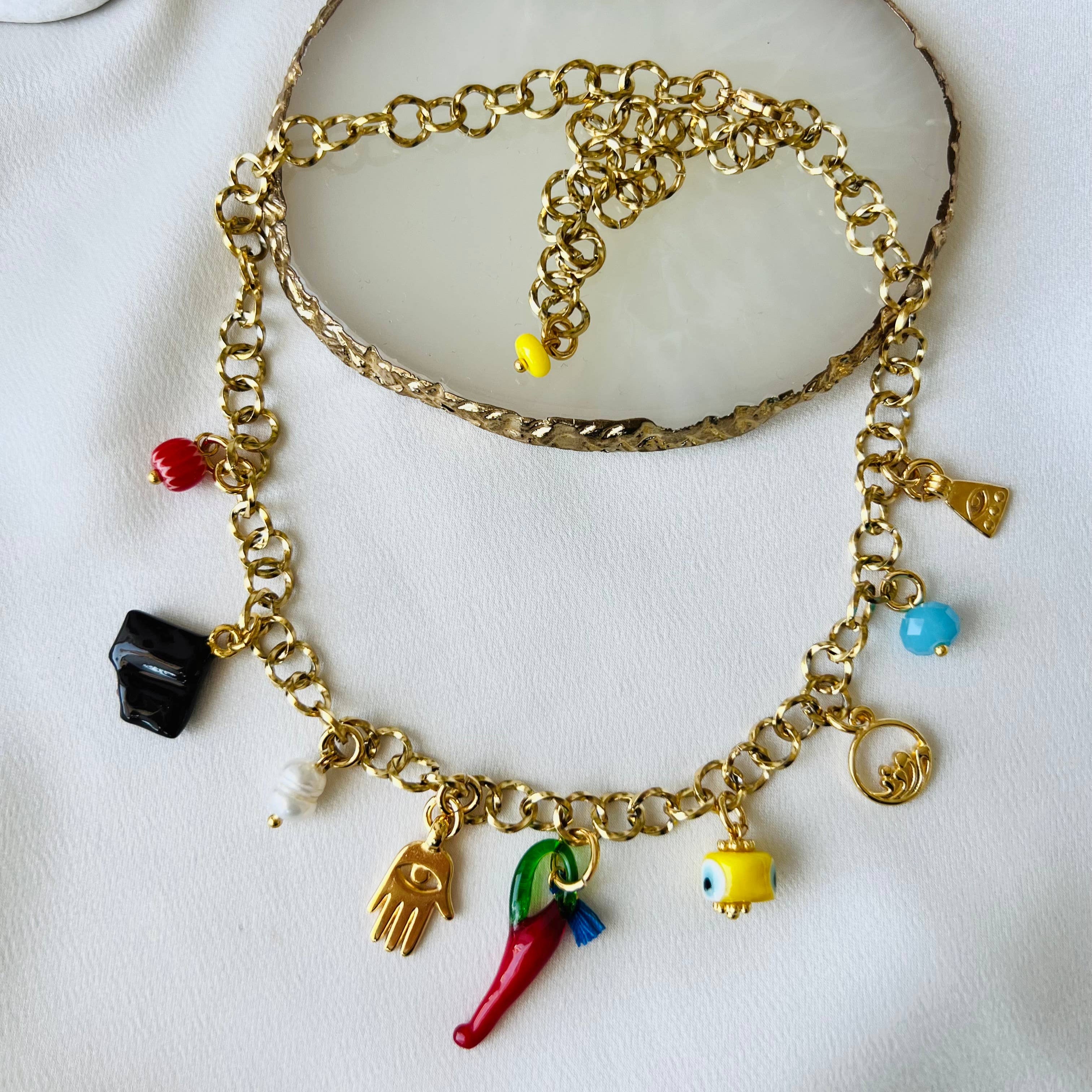 Multi-charm summer necklace featuring colorful charms on a gold chain, ideal for stylish summer outfits.