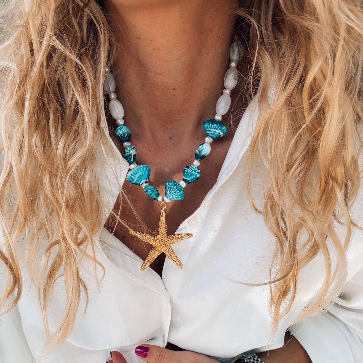Gold large starfish necklace with turquoise beads and scallop shells, perfect for summer beach outfits.